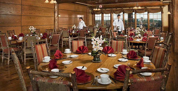 Student server by tables with fan-shaped napkins 